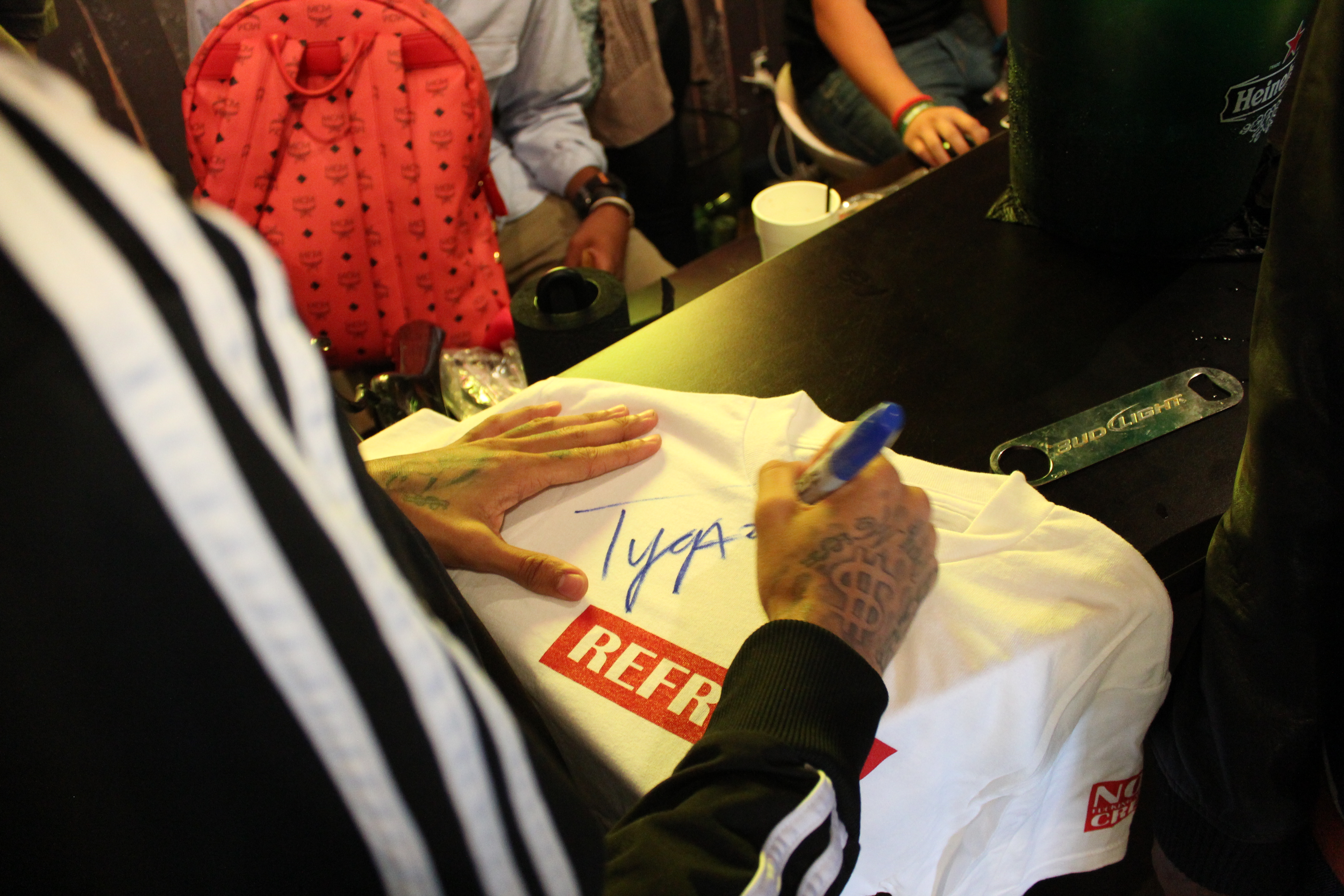 TYGA SIGNING AUTOGRAPHS FOR